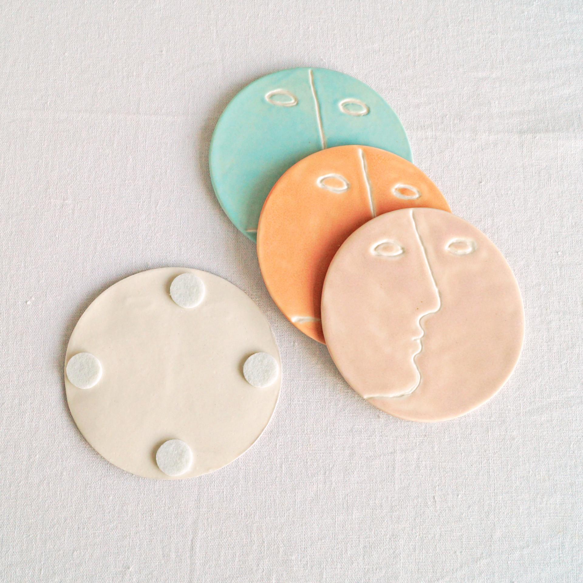 Face, coasters, pastel colour, mint, orange, pink, grey, porcelain face, ceramics with faces, face coasters, coasters with fa